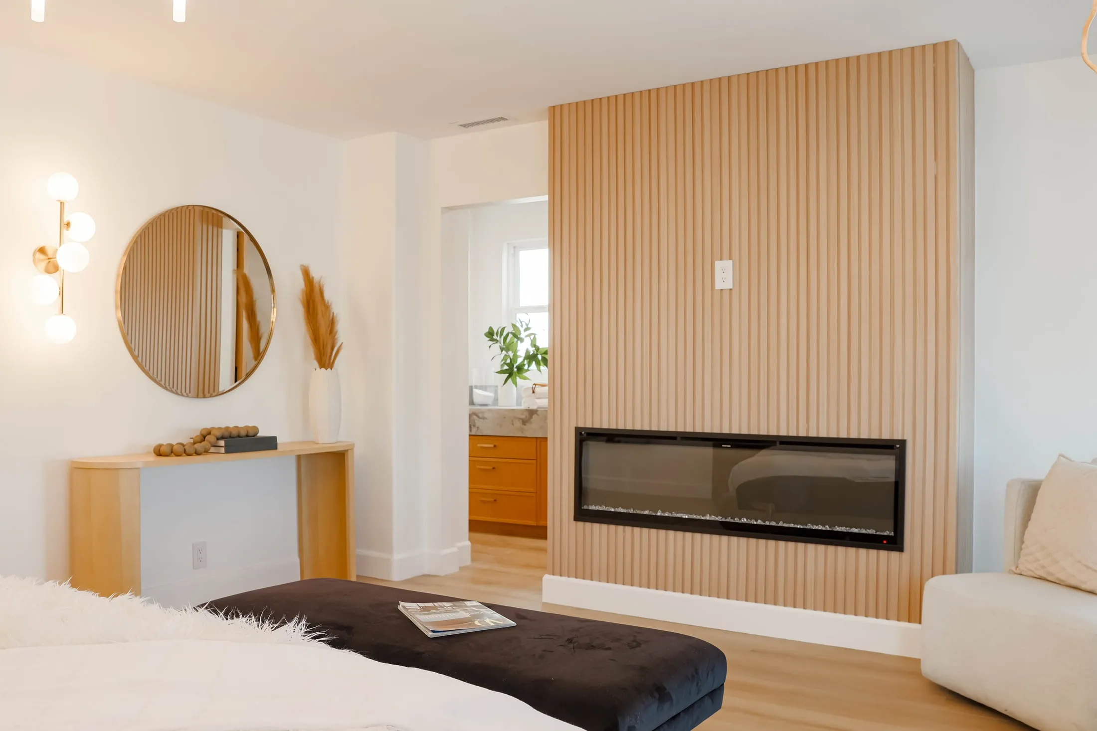 Vertical wood slat fireplace wall and matching console in the bedroom